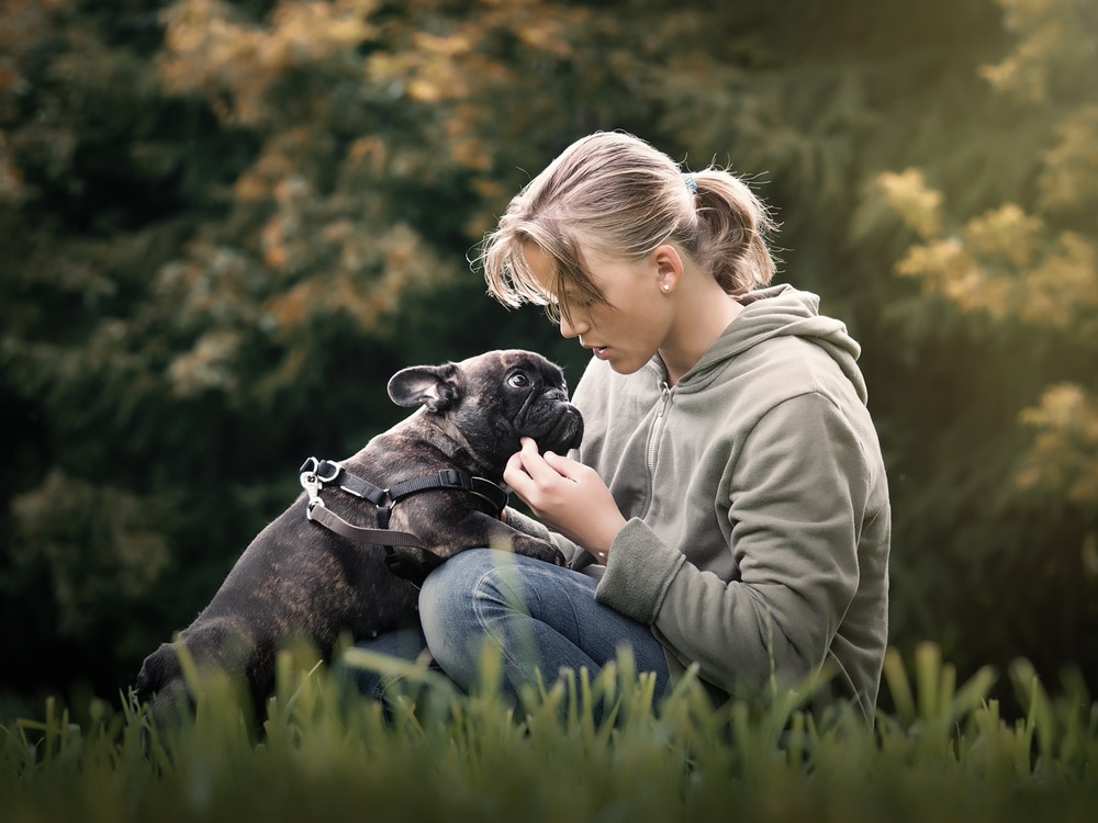 woman playing with her dog in a park